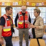 Deux membres de l’État-major de conduite régional du Lötschental avec la présidente de la Confédération Karin Keller-Sutter.